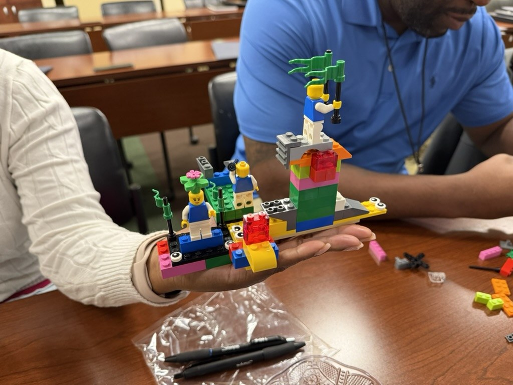 A participant sharing a LEGO Serious Play model